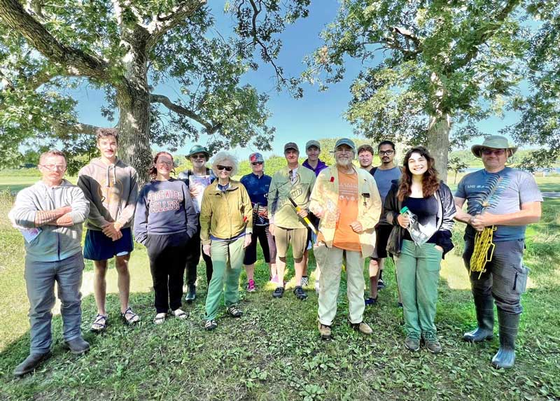 A group of volunteers standing in front of some trees