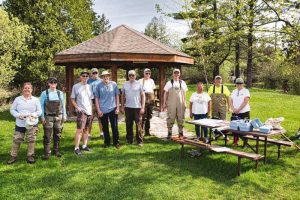 A small group of people standing in a park 