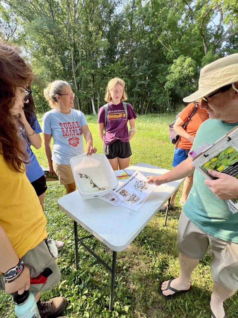 A group of people outside looking at a map