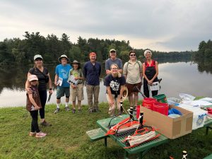 A large group of people in front of a lake