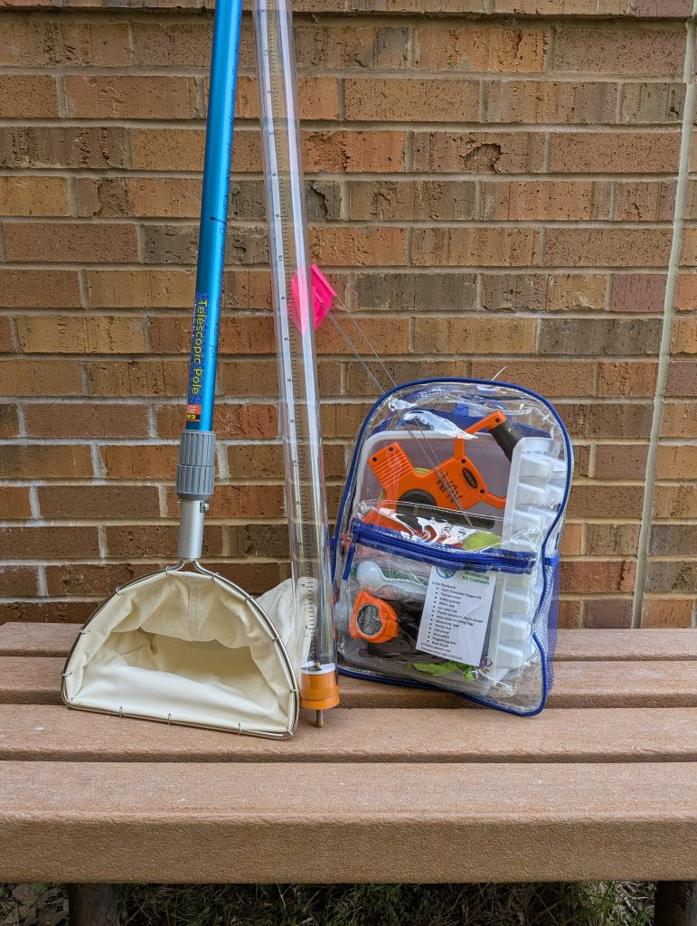 The baseline monitoring kit, including a net, 120cm transparency tube, and clear backpack filled with monitoring supplies.