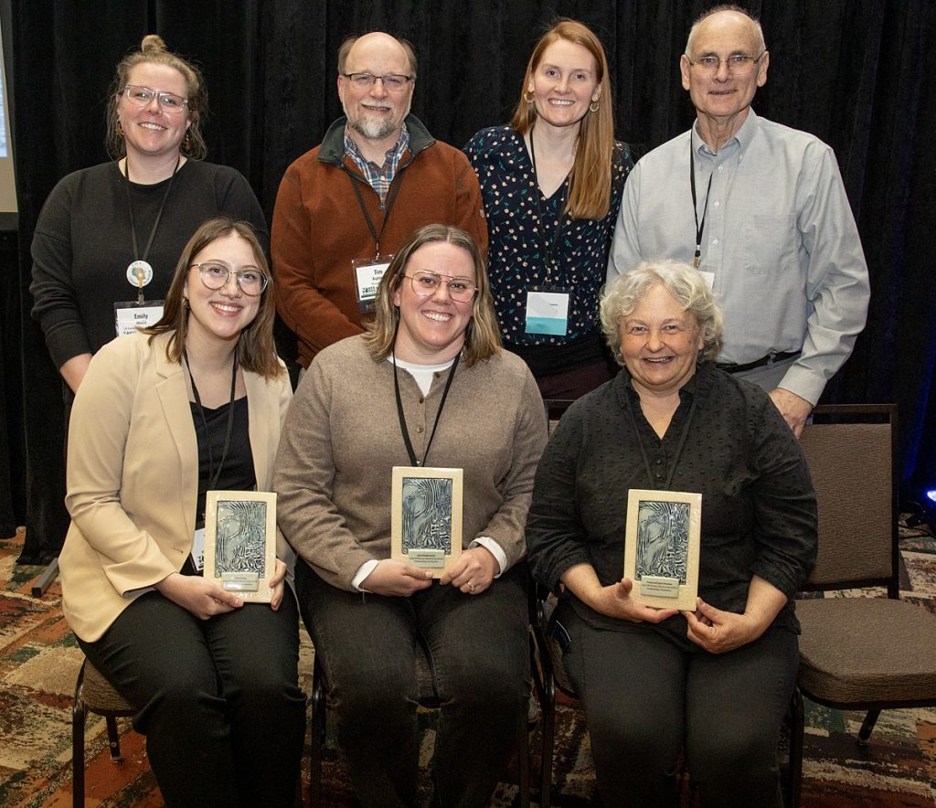 Award recipients hold their stream awards in a photo with DNR and Extension staff.